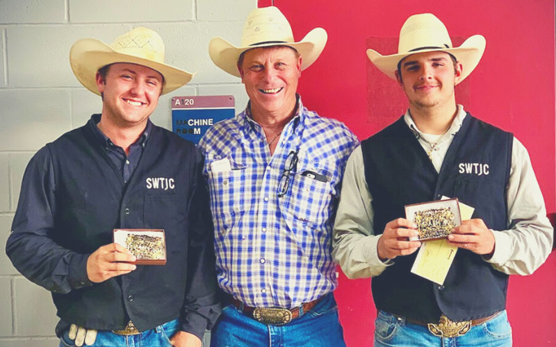 Southwest Texas Junior College rodeo coach Joey Almand (center) with team ropers Tristan Sullivan and Will Farris after their team roping title win at Texas A&M University. The SWTJC rodeo team competed March 12-13 in Bryan.