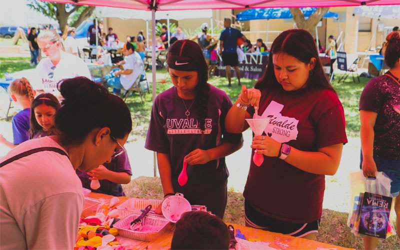 Two participants visit an interactive booth at the Uvalde Strong Wellness & Resource Fair on Saturday, June 18, 2022.